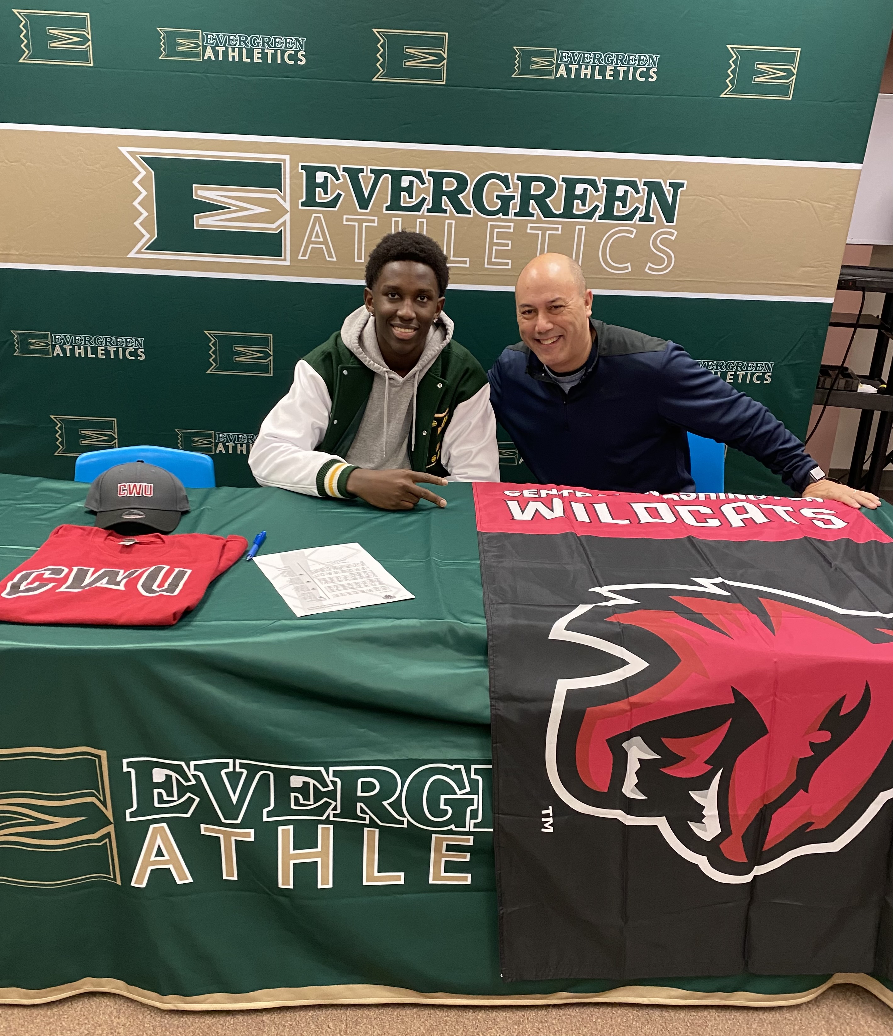 Coach Scott Laigo celebrating signing day with a student-athlete